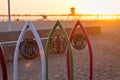 Huntington Beach, CA, USA - April 28, 2018: Sunlight filters through the famous iron surfboards along the bike path as the sun set