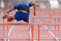 A hurdle runner leaping over the hurdles