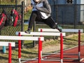 Hurdle runner running drills over hurdles Royalty Free Stock Photo