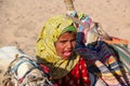 HURGHADA, EGYPT - Apr 24 2015: The young girl-cameleer from Bedouin village in Sahara desert with her camel, shouting inviting