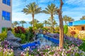 Pictures of a water pool with bridge, garden with flowers and a decorative statues