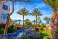 Pictures of a water pool with bridge, garden with flowers and a decorative statues