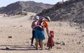 Bedouin children entertain tourists. Kids of the Sahara desert. Children-natives extort gifts from tourists