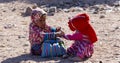 Bedouin children entertain tourists. Kids of the Sahara desert. Release from the leash