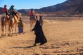 Group of tourists riding camels in Arabian desert, Egypt Royalty Free Stock Photo