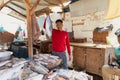 HURGHADA, EGYPT - FEBRUARY 19, 2022: Local fish seller sitting in the market. Fresh caught fishes at fish market Royalty Free Stock Photo