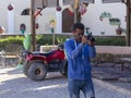 Funny Arab photographer. Photographing tourists during a Safari in the Sahara desert