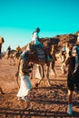 Hurghada Egypt January 2022 Tourists riding the camels in the middle of the desert. Popular tourist attraction of camel riding in