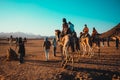 Hurghada Egypt January 2022 Tourists riding the camels in the middle of the desert. Popular tourist attraction of camel riding in