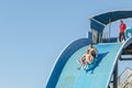 Hurghada, Egypt. November 19 2018 The guy with the girl down the water slide. The girl is afraid to go down the hill. Couple at Royalty Free Stock Photo