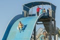 Hurghada, Egypt. November 19 2018 The guy with the girl down the water slide. The girl is afraid to go down the hill. Couple at Royalty Free Stock Photo