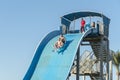 Hurghada, Egypt. November 19 2018 The guy with the girl down the water slide. The girl is afraid to go down the hill. Couple at Royalty Free Stock Photo