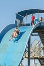 Hurghada, Egypt. November 19 2018 The guy with the girl down the water slide. The girl is afraid to go down the hill. Couple at Royalty Free Stock Photo