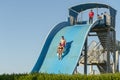 Hurghada, Egypt. November 19 2018 The guy with the girl down the water slide. The girl is afraid to go down the hill. Couple at Royalty Free Stock Photo