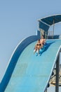 Hurghada, Egypt. November 19 2018 The guy with the girl down the water slide. The girl is afraid to go down the hill. Couple at Royalty Free Stock Photo