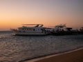 Hurghada, Egypt - October 3, 2021: Beautiful sunrise on the Red Sea in Egypt. The yachts are near the pier on the sandy beach Royalty Free Stock Photo