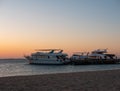 Hurghada, Egypt - October 3, 2021: Beautiful sunrise on the Red Sea in Egypt. The yachts are in a row near the pier on the sandy Royalty Free Stock Photo
