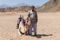 Old Bedouin man with his camel in the desert near Hurghada, Egypt Royalty Free Stock Photo