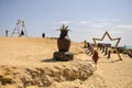 Hurghada, Egypt - October 2022: People are relaxing on the beach on sunny day. Women are photographed on a wooden swing.