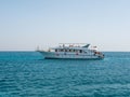 Hurghada, Egypt - September 22, 2021: People ride and relax on a large yacht on the azure red sea. Tourists are offered snorkeling