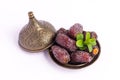 HURMA, Dates. Dried dates fruit with bronze bowls on white background. Royalty Free Stock Photo