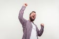 Hurray! Portrait of overjoyed winner, bearded man screaming yes i did it. indoor studio shot isolated on white background