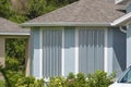 Hurricane shutters made from steel mounted for protection of house windows. Protective measures before natural disaster Royalty Free Stock Photo