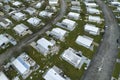 Hurricane strong wind destroyed suburban house roofs in Florida mobile home residential area. Consequences of natural