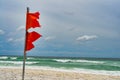 Hurricane warnings double red flags flying on the beach