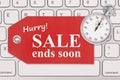 Hurry sale end soon message on a gift tag on gray keyboard