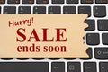 Hurry sale end soon message on a wood sign on a keyboard