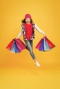 Hurry up, sale ends. Energetic kid carry shopping bags. Emotional shopper haste yellow background. Childrens clothing at