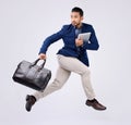 Hurry, work and an Asian man jumping for business isolated on a white background in a studio. Fast, serious and a