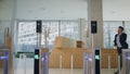 Hurrying man using smartwatch for open office turnstile running on workplace.