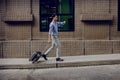 Hurrying to get on a Business Trip. Stressed Passenger Businessman Walking with Suitcase in the City