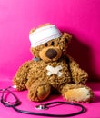 Hurt child`s teddy bear with stomach and head bandage Royalty Free Stock Photo