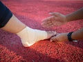 Hurted leg with holding hands Royalty Free Stock Photo