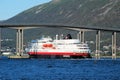 Tromso - Hurtigruten under the Tromso bridge - cruise service along Norways coast