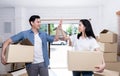 Husband and attractive wife helping each other to lift the box Happily, to move into a new home