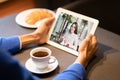 Husband Calling Wife On Digital Tablet Sitting In Cafe, Cropped