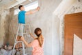 Husband climbed up the ladder and used a tape measure