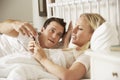 Husband Complaing As Wife Uses Mobile Phone In Bed Royalty Free Stock Photo