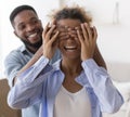 Husband Covering Wife`s Eyes Before Showing New Home Standing Indoor