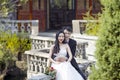 Husband hug wife, groom embrace his bride, sit on a cloister Royalty Free Stock Photo