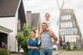 Husband hugging his wife and caring daughter on neck