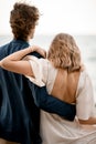 Husband hugs his wife against the background of the sea and sky Royalty Free Stock Photo