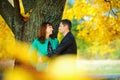 Husband hugs and kisses his wife standing under a tree Royalty Free Stock Photo