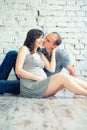 Husband kisses his pregnant wife