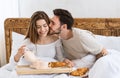 Husband kisses wife on cheek, happy wife pours coffee