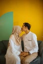 husband kisses wife& x27;s forehead as love sign during Eid Mubarak